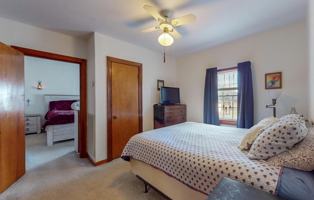 bedroom with light colored carpet and ceiling fan