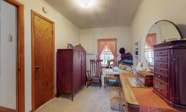 bedroom featuring ornamental molding and light carpet