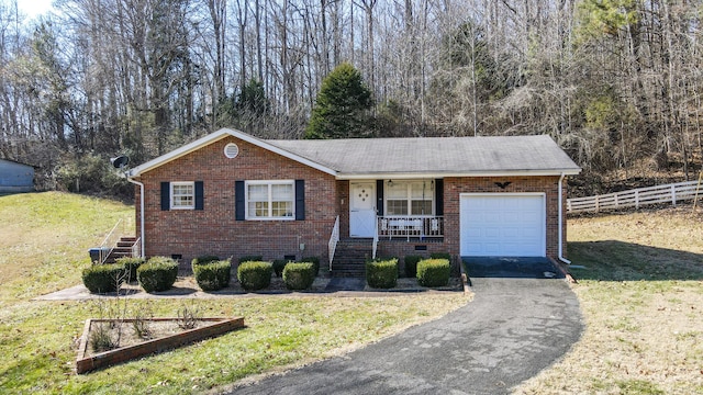 ranch-style home with a garage and a front lawn