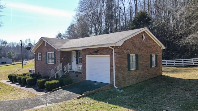 single story home with a garage and a front lawn