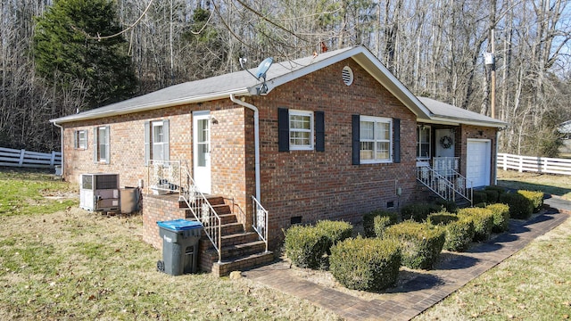 ranch-style home with central AC and a garage