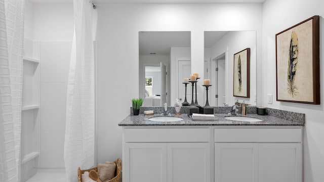 bathroom featuring vanity and curtained shower