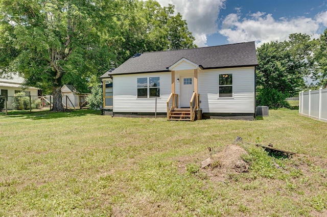 view of front of home featuring central AC unit and a front yard