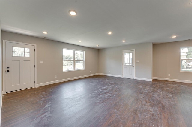 entrance foyer featuring a healthy amount of sunlight and dark wood-type flooring