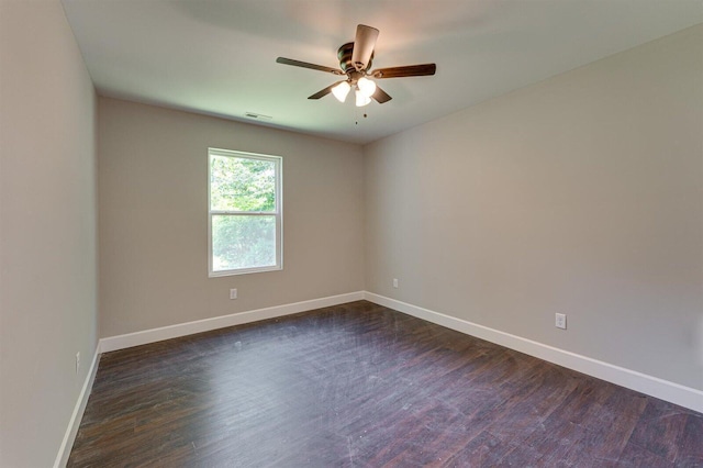 empty room with dark wood-type flooring and ceiling fan