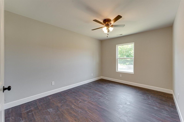 spare room with dark hardwood / wood-style floors and ceiling fan