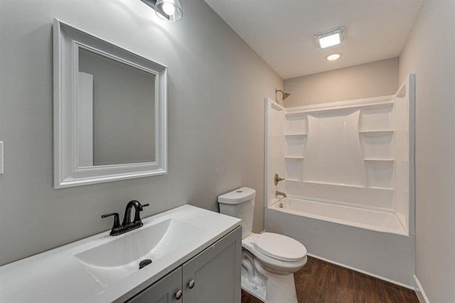 full bathroom featuring vanity, hardwood / wood-style flooring,  shower combination, and toilet