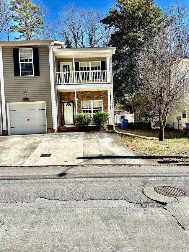 view of front of house featuring a garage and a balcony