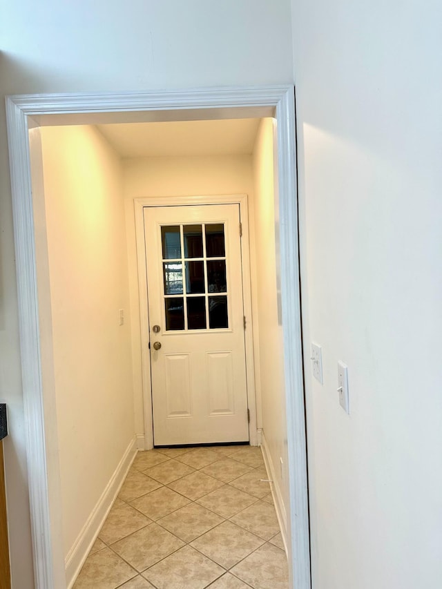 doorway to outside with light tile patterned floors