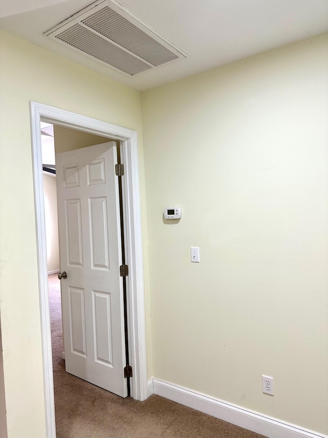 hallway with light colored carpet