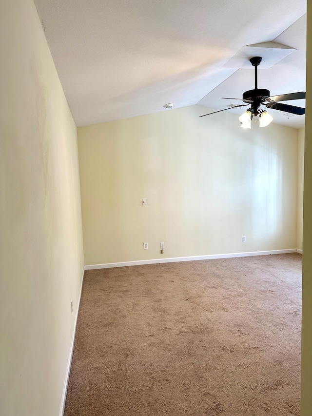 carpeted spare room with vaulted ceiling and ceiling fan