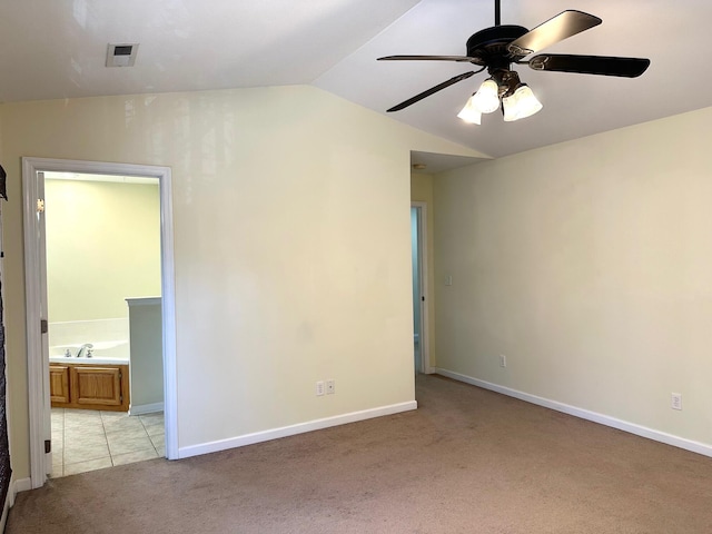 carpeted empty room with lofted ceiling and ceiling fan