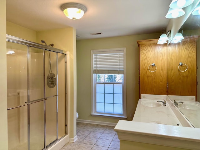 bathroom featuring walk in shower, tile patterned floors, vanity, and toilet