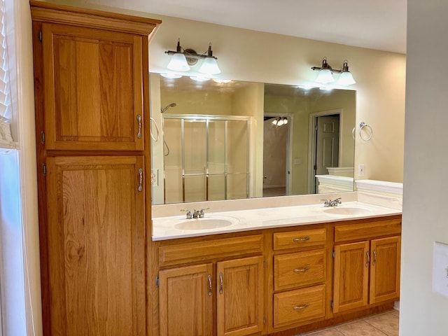 bathroom with tile patterned floors, vanity, and an enclosed shower