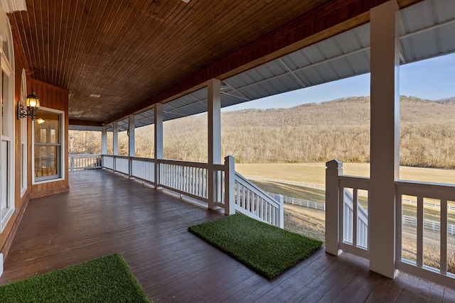 wooden terrace with a mountain view and a porch