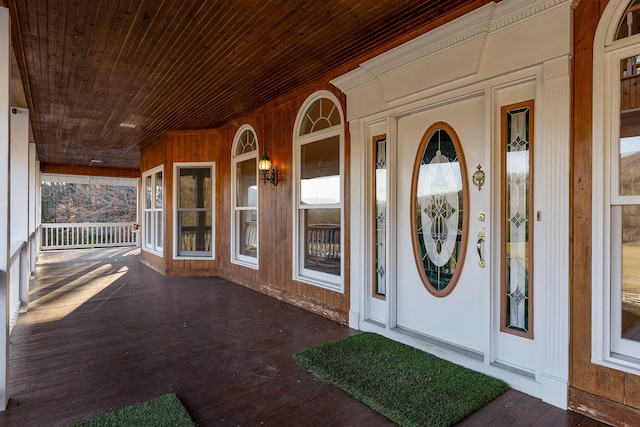 view of exterior entry with a porch