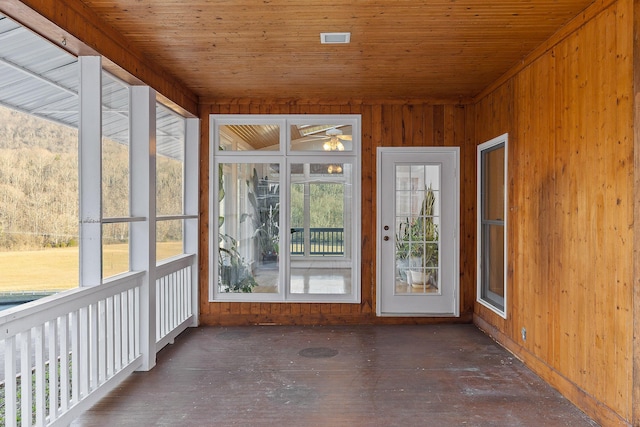 unfurnished sunroom with wood ceiling and a wealth of natural light