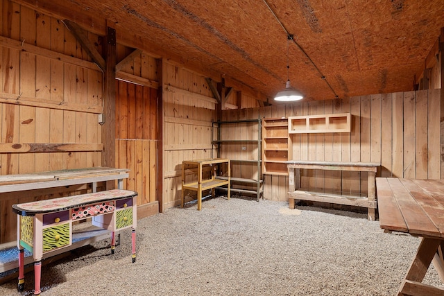 misc room with carpet floors and wood walls