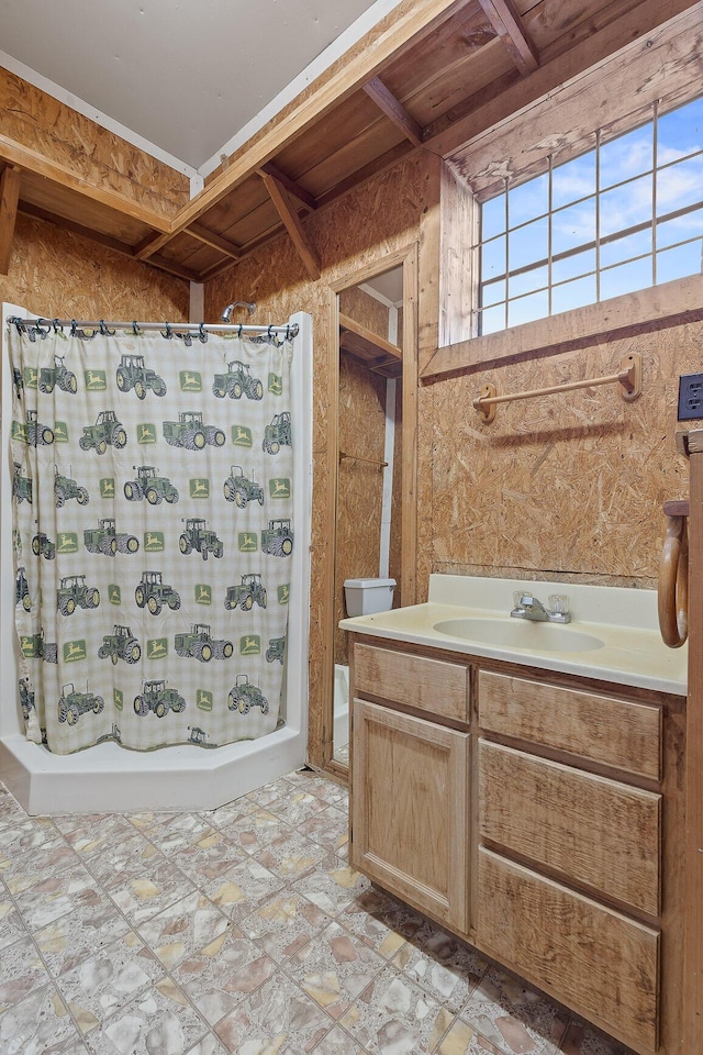 bathroom featuring vanity and shower / tub combo with curtain