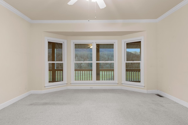 carpeted spare room with ornamental molding and ceiling fan