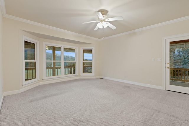 unfurnished room featuring ceiling fan, light colored carpet, and ornamental molding