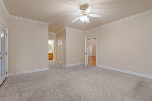 carpeted spare room with ceiling fan and ornamental molding