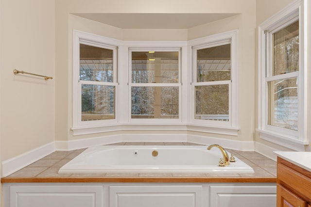 bathroom with vanity, a bathing tub, and a wealth of natural light