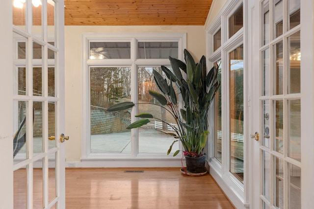 doorway to outside featuring light hardwood / wood-style floors, french doors, and wooden ceiling