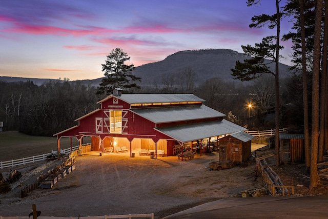 view of front of house featuring a mountain view and an outbuilding