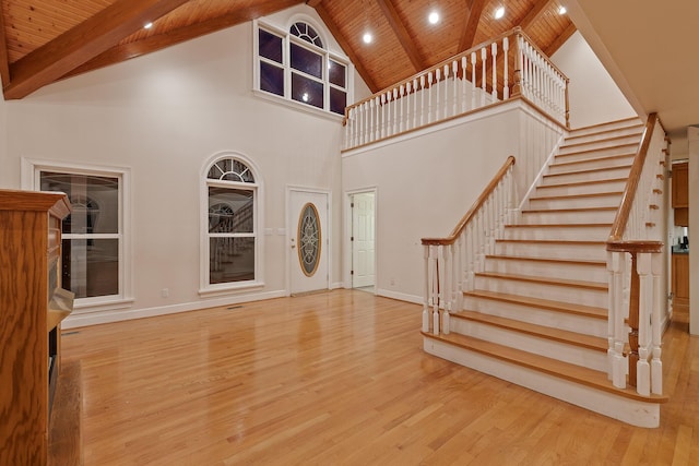 entrance foyer featuring wood ceiling, beam ceiling, high vaulted ceiling, and light hardwood / wood-style flooring