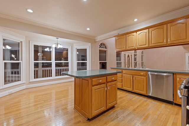 kitchen featuring pendant lighting, stainless steel appliances, ornamental molding, a kitchen island, and light wood-type flooring