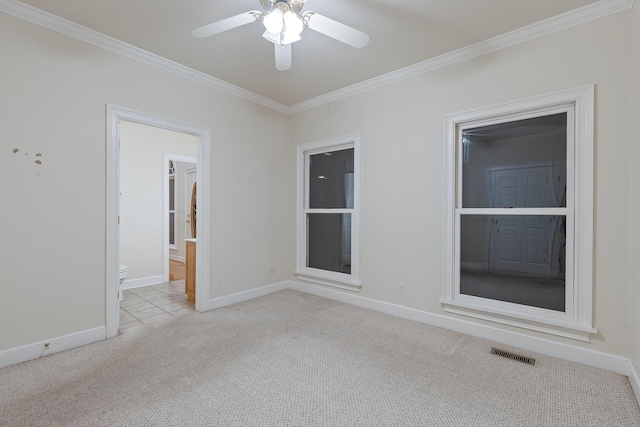 empty room featuring ceiling fan, ornamental molding, and light carpet