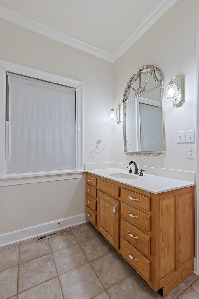 bathroom with tile patterned flooring, crown molding, and vanity