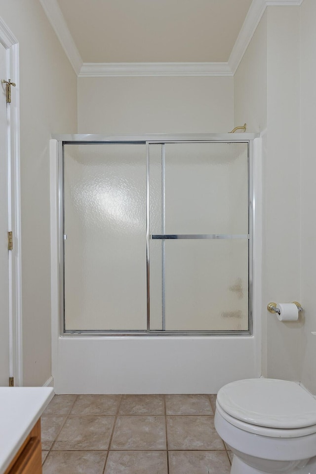 full bathroom with vanity, ornamental molding, toilet, and bath / shower combo with glass door