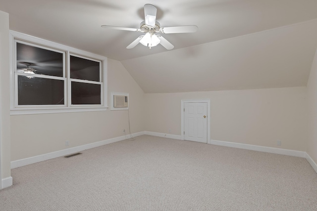 bonus room with vaulted ceiling, light colored carpet, and ceiling fan