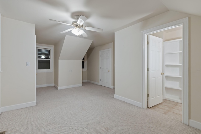 bonus room featuring lofted ceiling, light carpet, and ceiling fan