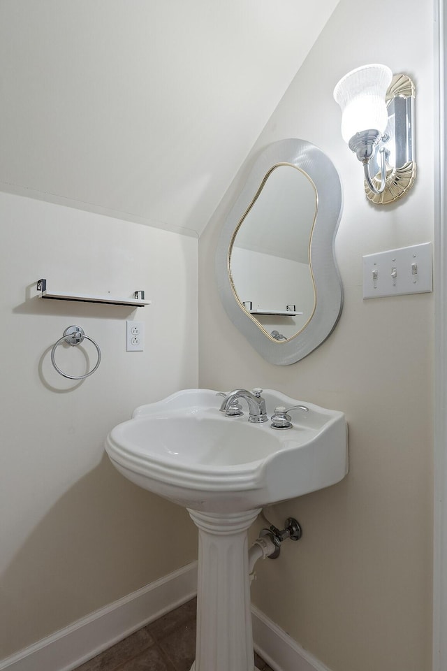 bathroom with tile patterned flooring and vaulted ceiling