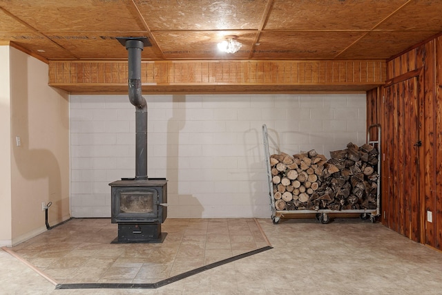 interior details with wooden walls and a wood stove