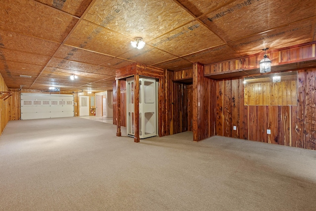 basement with carpet and wood walls