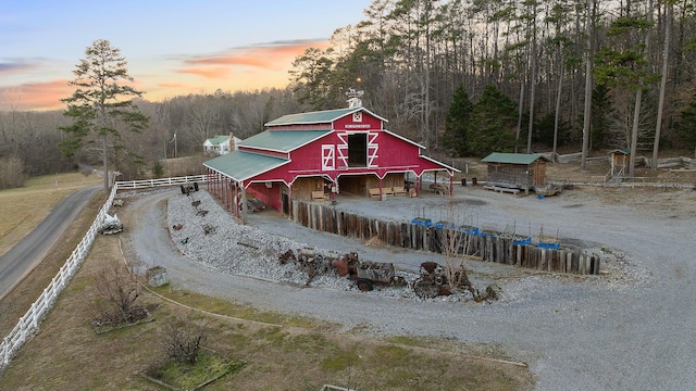 back house at dusk with an outbuilding