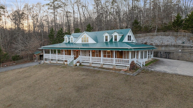 farmhouse inspired home with a yard and covered porch