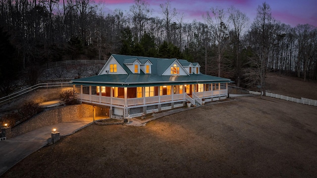 farmhouse-style home featuring a garage and covered porch