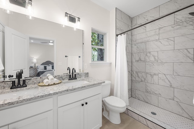 bathroom featuring toilet, wood-type flooring, vanity, and walk in shower