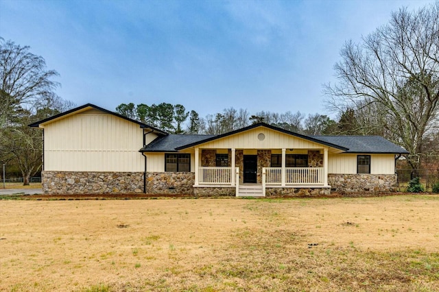 view of front of property with covered porch and a front yard