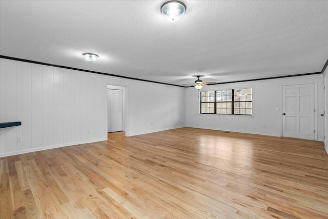 unfurnished living room featuring ornamental molding, ceiling fan, a textured ceiling, and light hardwood / wood-style floors