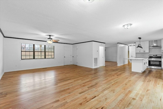 unfurnished living room with ceiling fan, a textured ceiling, and light wood-type flooring