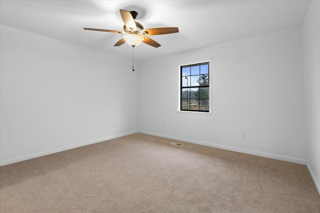 carpeted spare room with ceiling fan