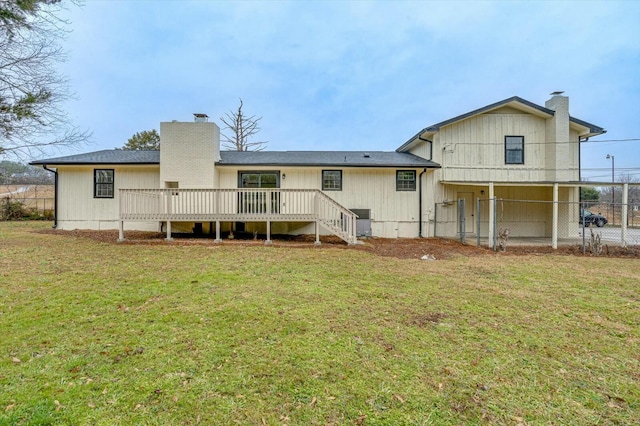 back of property featuring a yard and a deck