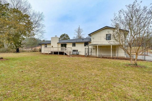 back of property featuring a wooden deck, central AC unit, and a lawn