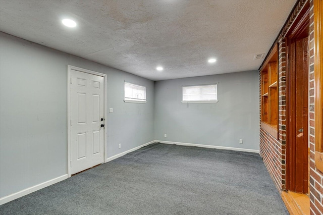 basement with carpet floors and a textured ceiling